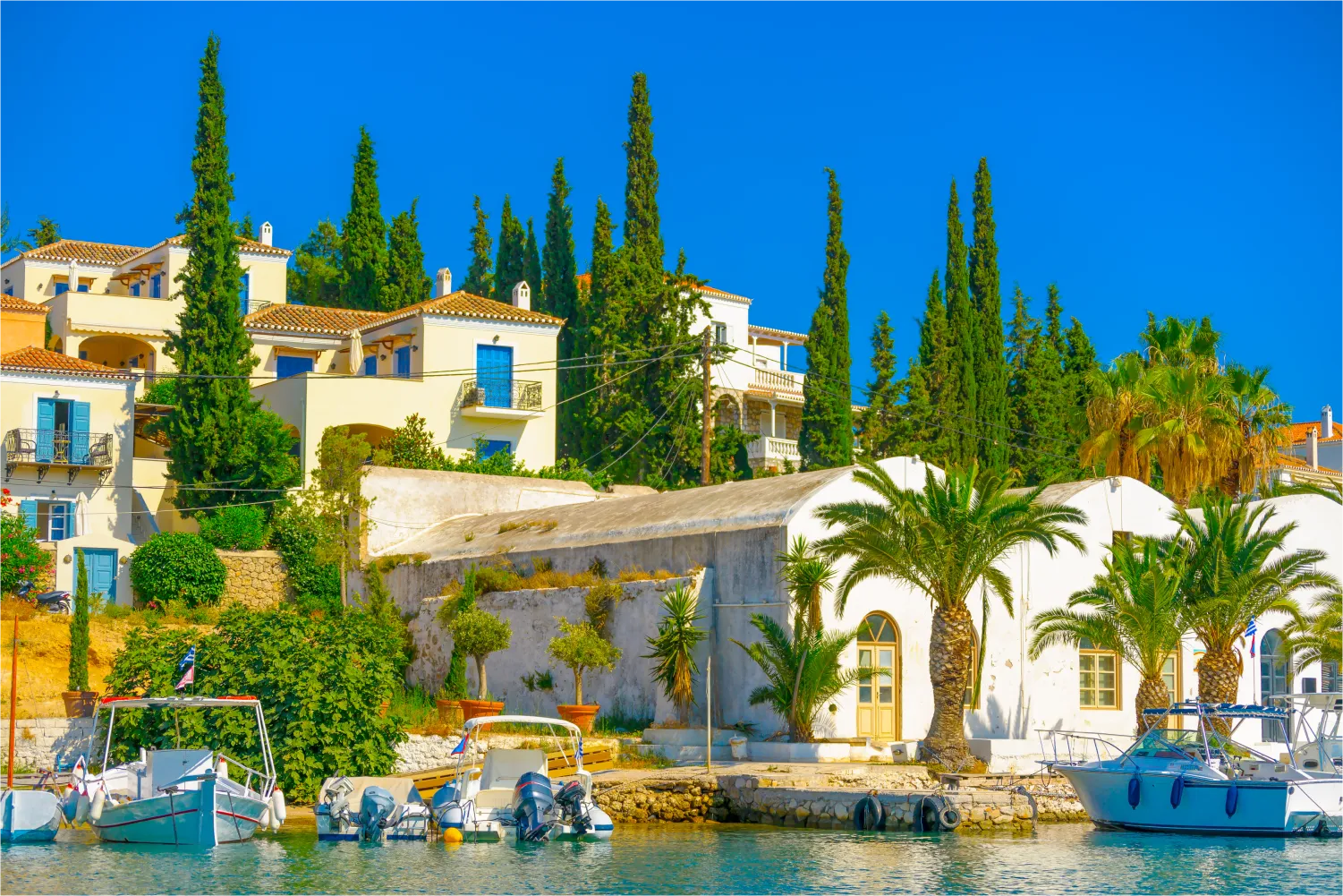 Der alte Hafen von Spetses mit seinen hohen Bäumen und traditionellen Häusern
